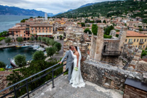 Couple planning their luxury elopement with notebook and destination photos