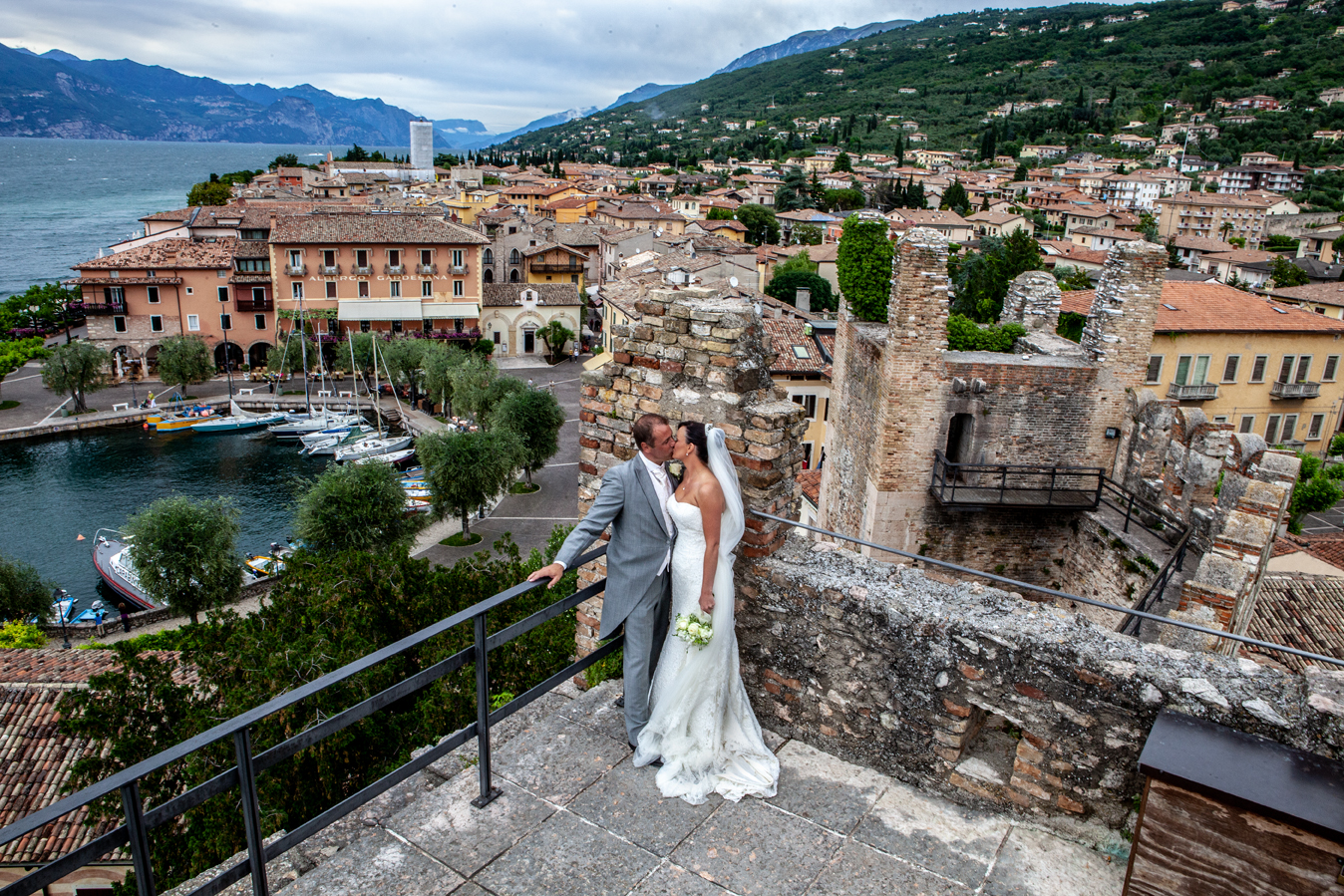 Couple planning their luxury elopement with notebook and destination photos